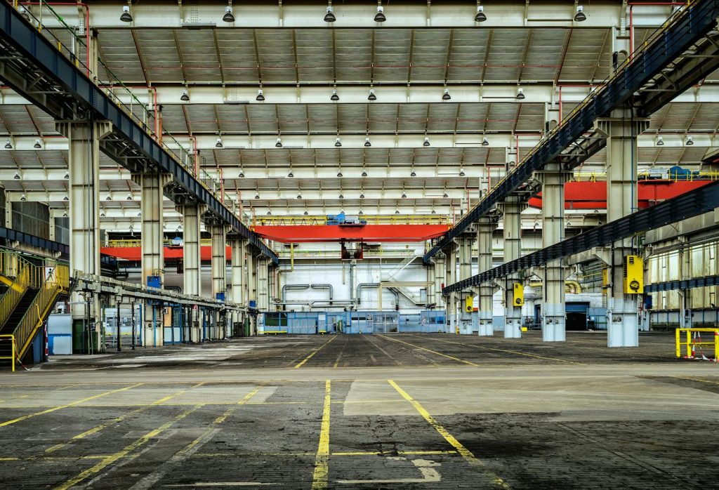 Expansive industrial warehouse interior showcasing steel framework and spacious layout for diverse manufacturing needs.
